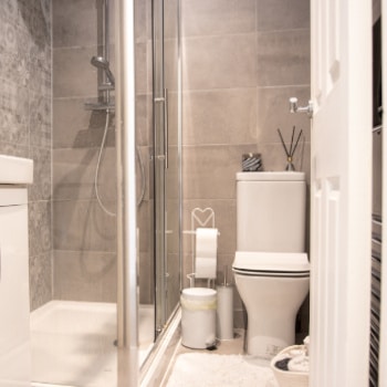 a uk bathroom, with white and grey as the main colours